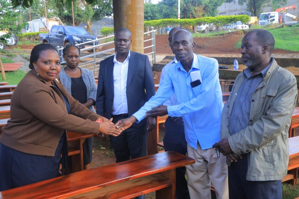 Hon. Rose Nakafeero Ssuka handing over furniture to the beneficuary schools